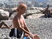 Hot milf gets naked at the beach and shows off her extraordinaire assets
